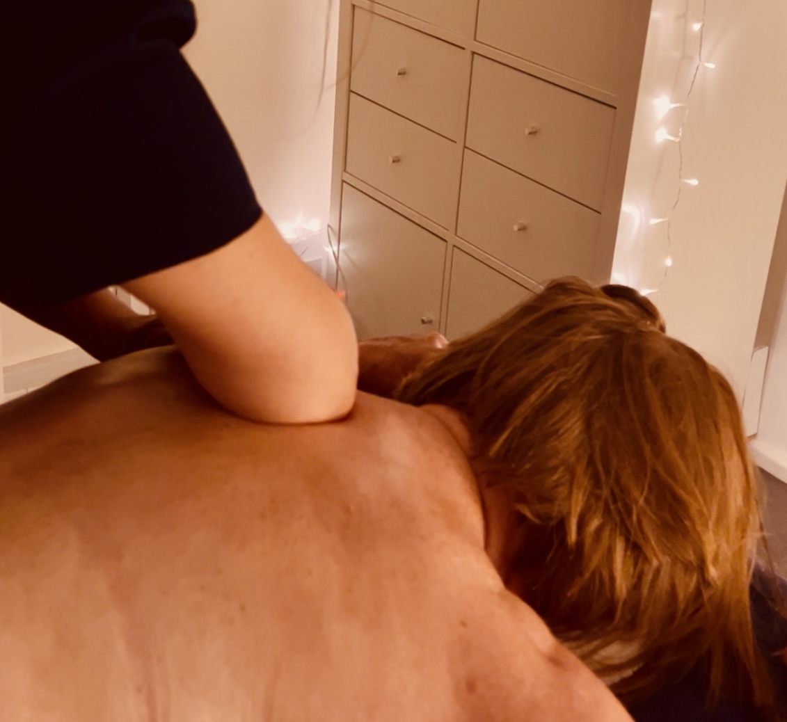 Forearm pressure applied during a deep tissue back massage