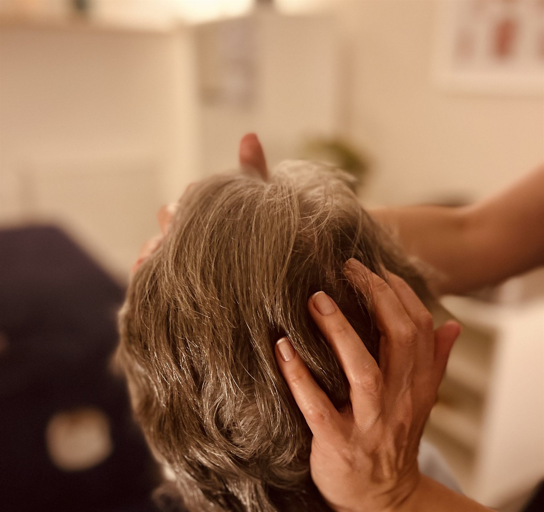 Indian head massage viewed from behind the client