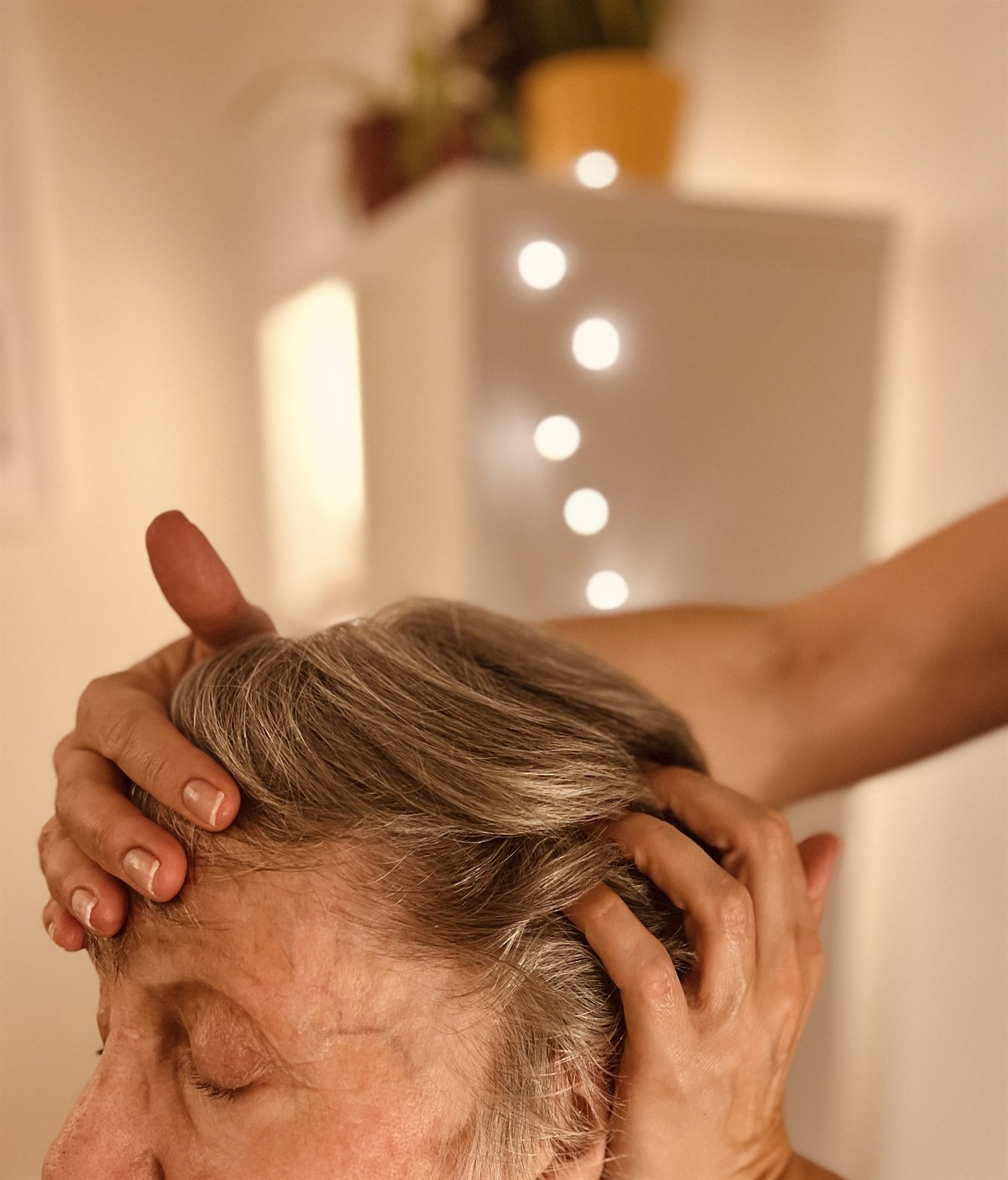 Indian head massage working across the scalp with both hands